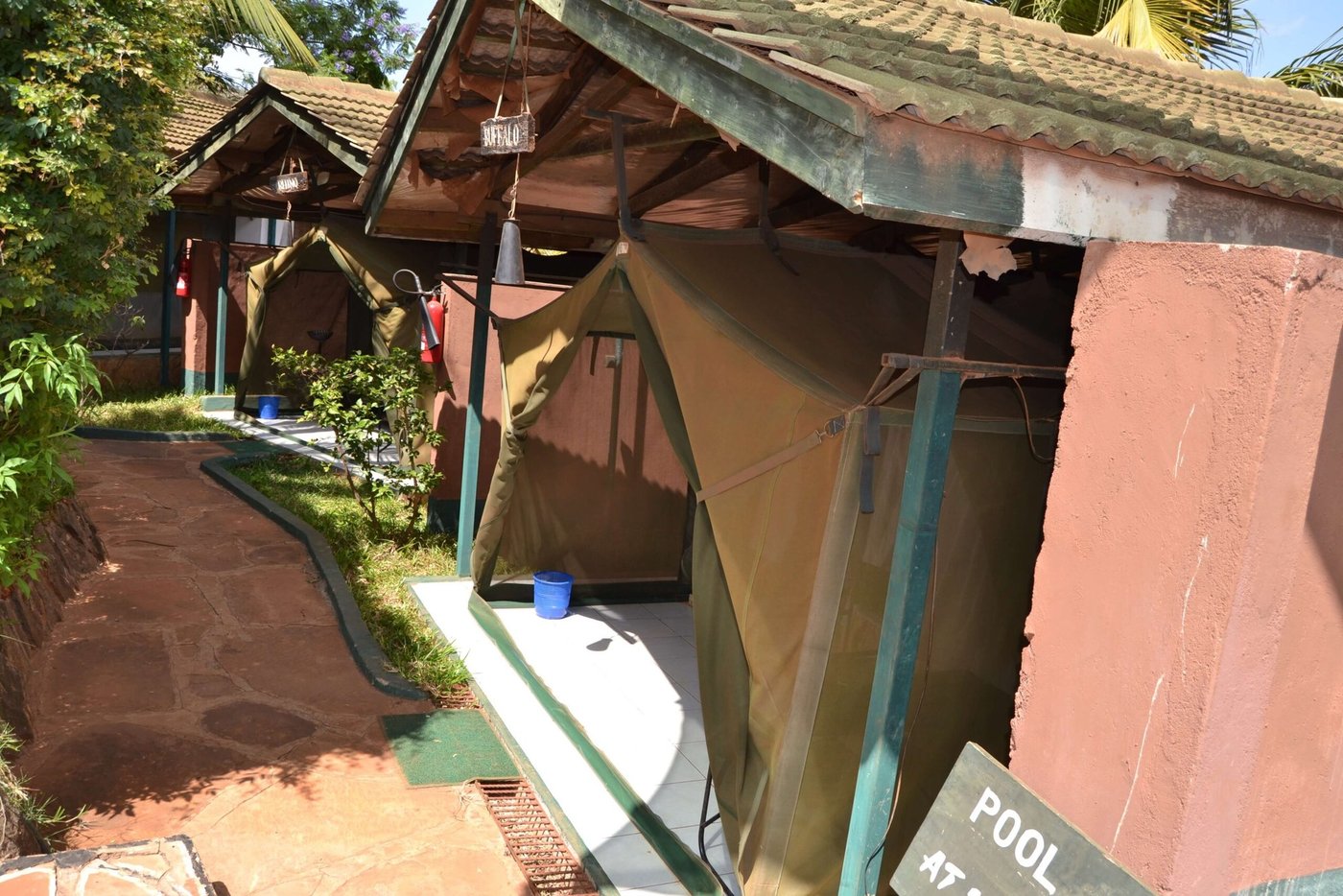 Canvas tent cabins named for wildlife line a stone path at Impala Safari Lodge in Tsavo