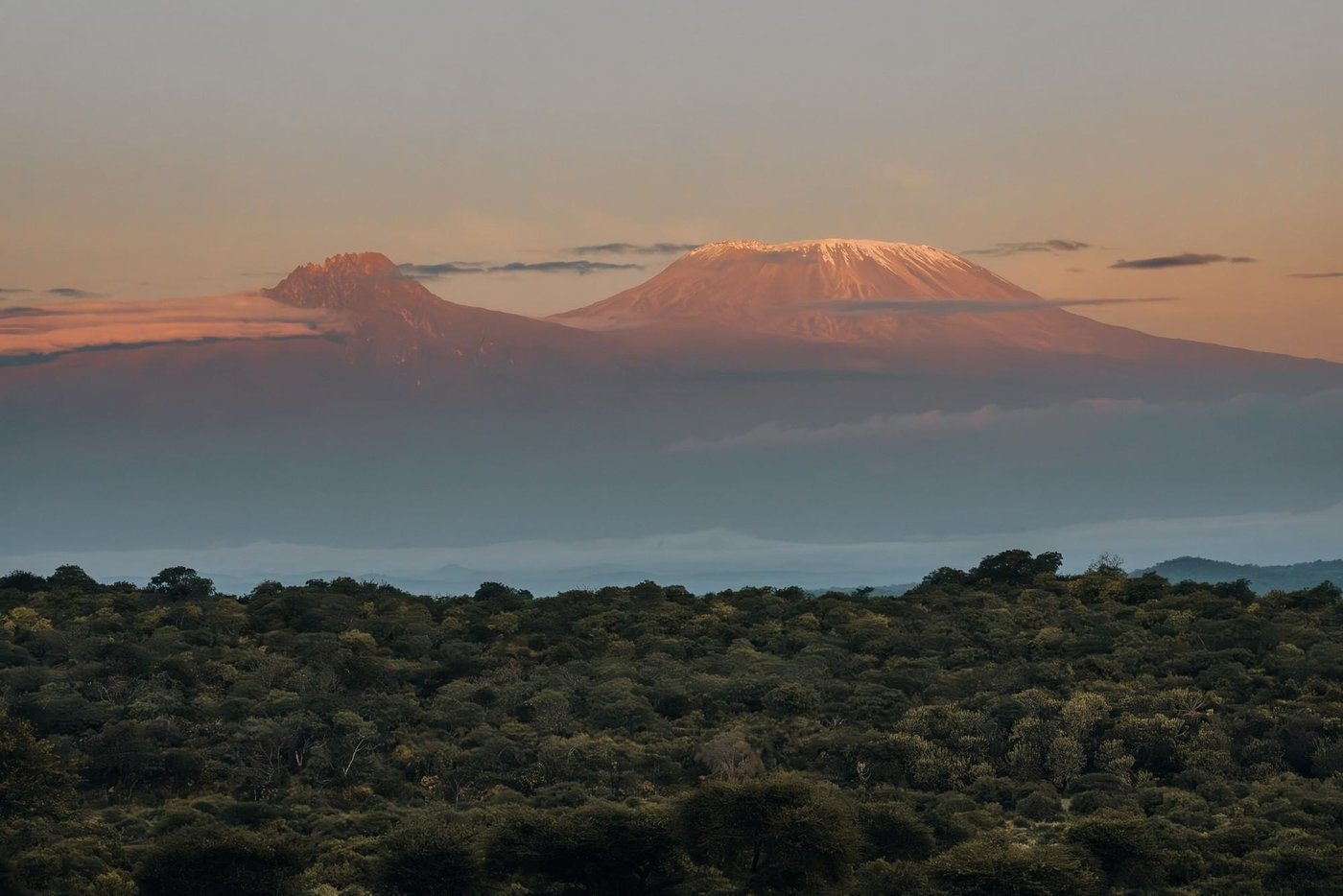Mount Kilimanjaro glowing at sunset beyond the hills at Kilaguni Serena Safari Lodge in Tsavo