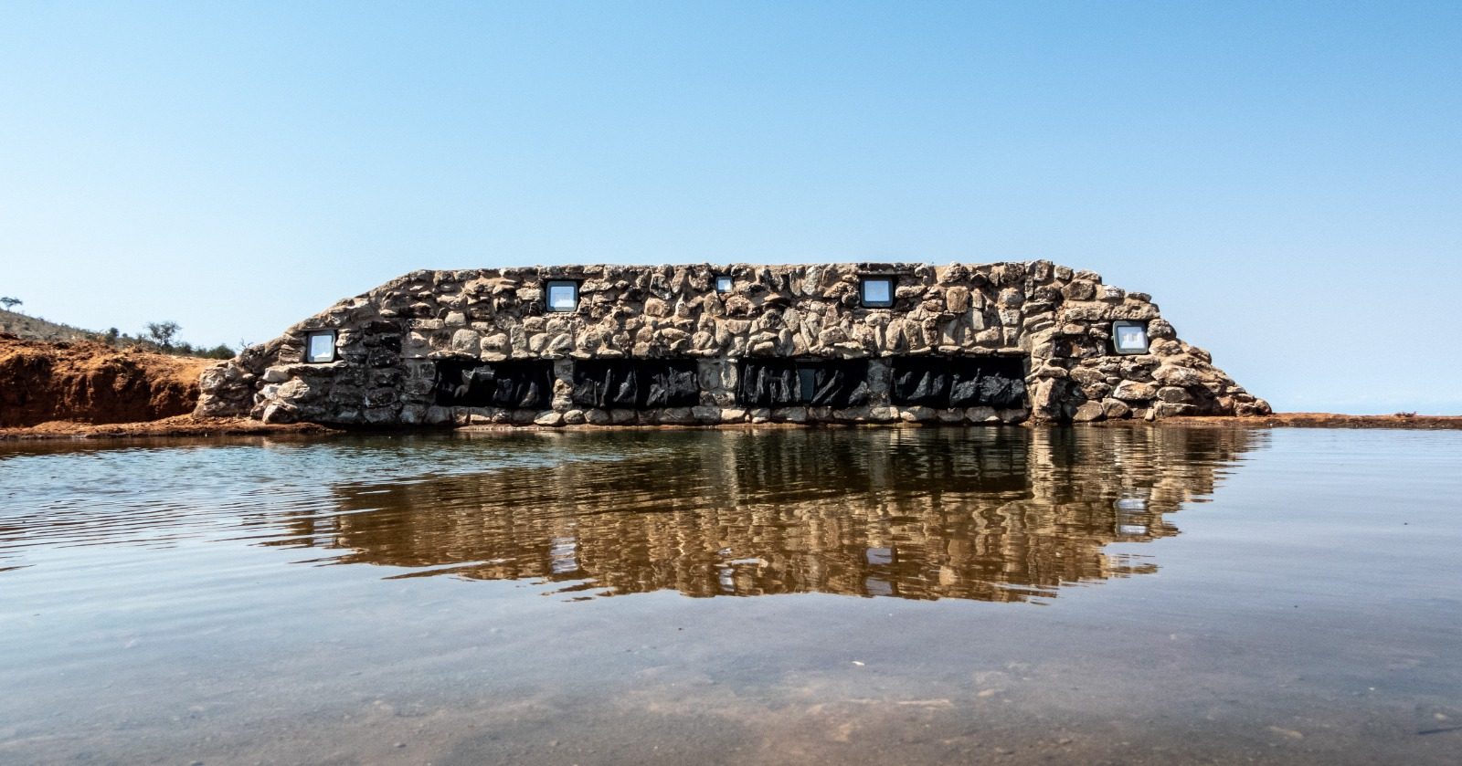 The stone photographic hide, sunk to water level at the waterhole