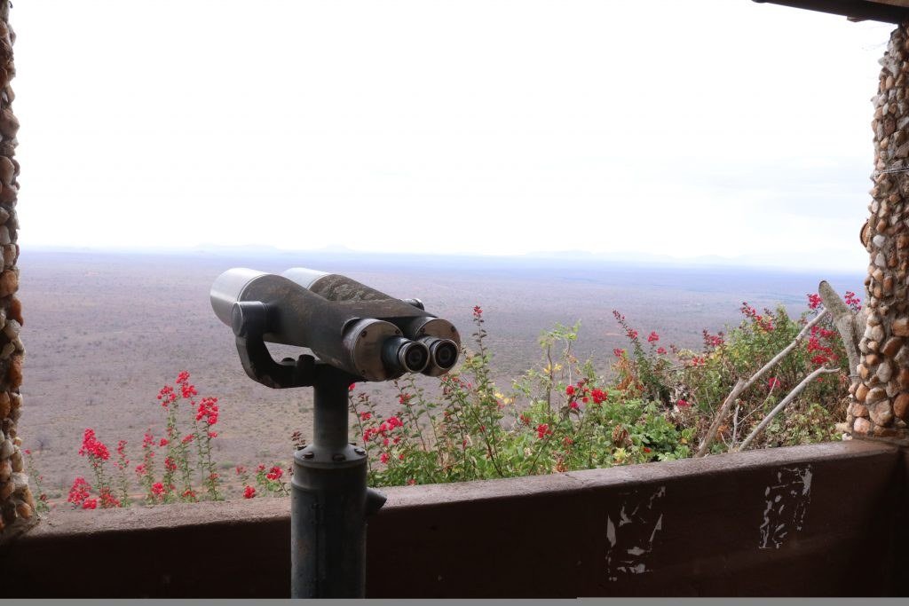 Mounted binoculars overlook the Tsavo plains from a viewpoint at Ngulia Safari Lodge