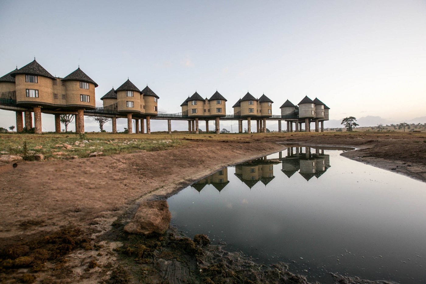 Raised wooden walkway linking the stilted rondavels over the waterhole at Salt Lick Safari Lodge