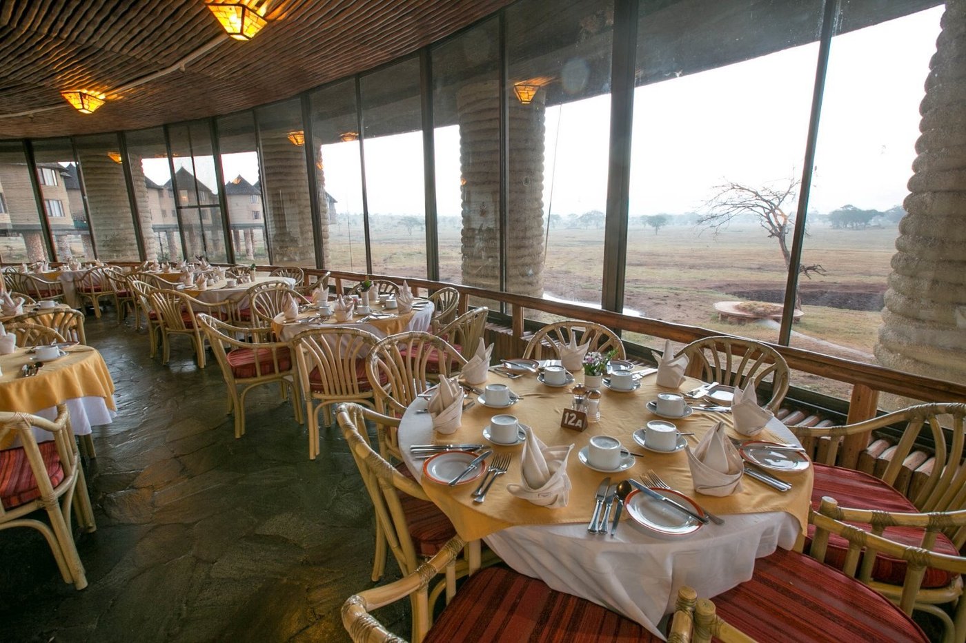 Dining room with floor-to-ceiling windows overlooking the plains at Salt Lick Safari Lodge