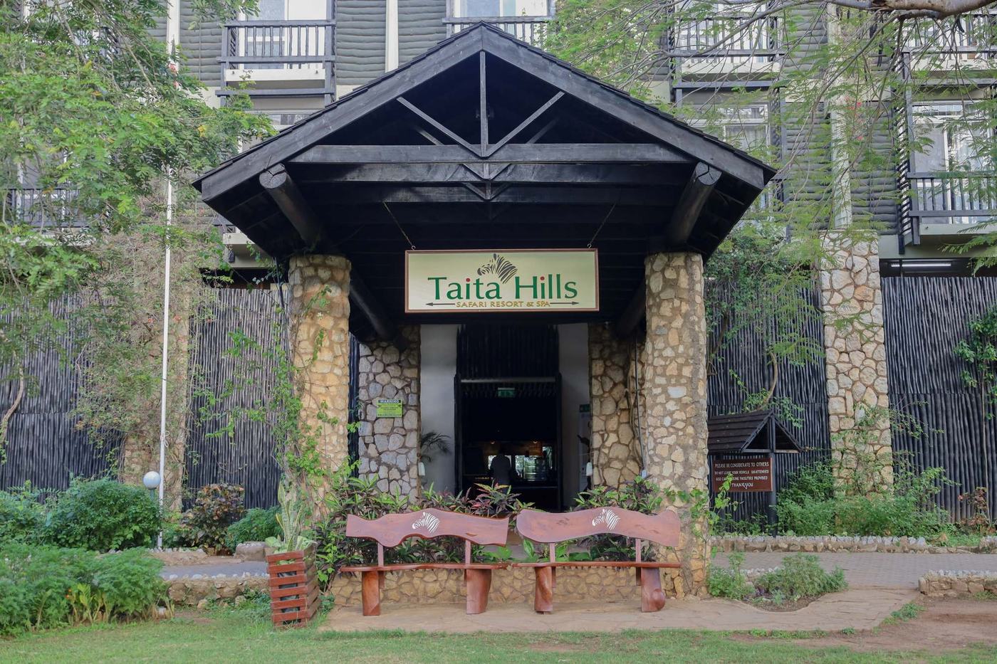 Stone entrance with the Taita Hills Safari Resort & Spa sign near Tsavo