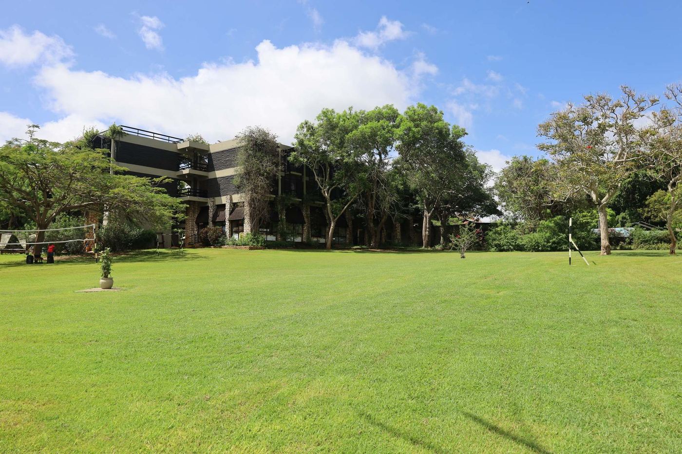 Wide lawn in front of the resort buildings at Taita Hills Safari Resort & Spa