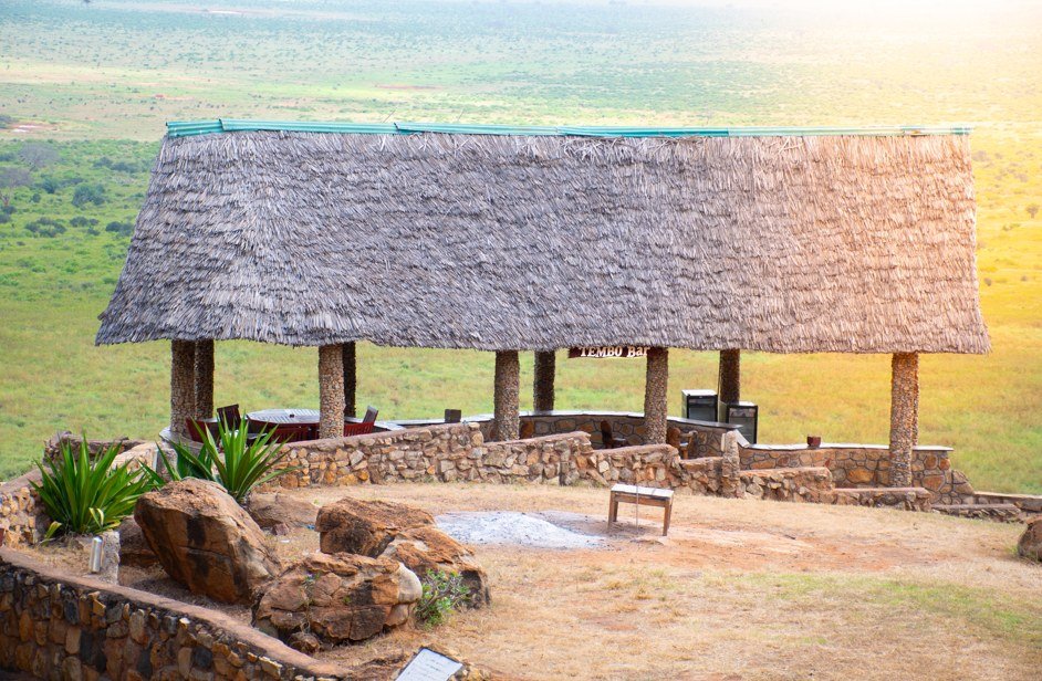 Thatched viewpoint pavilion called Tembo Bar overlooks the plains at Voi Safari Lodge in Tsavo